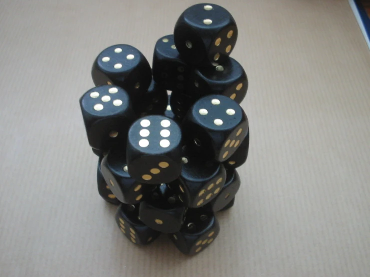 a black and gold dice stacked on each other