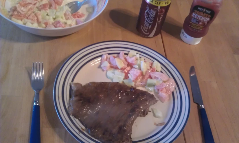 a plate with meat, potatoes and a salad on it