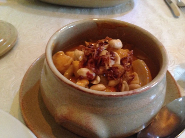 a table with two bowls of food sitting on top of each other