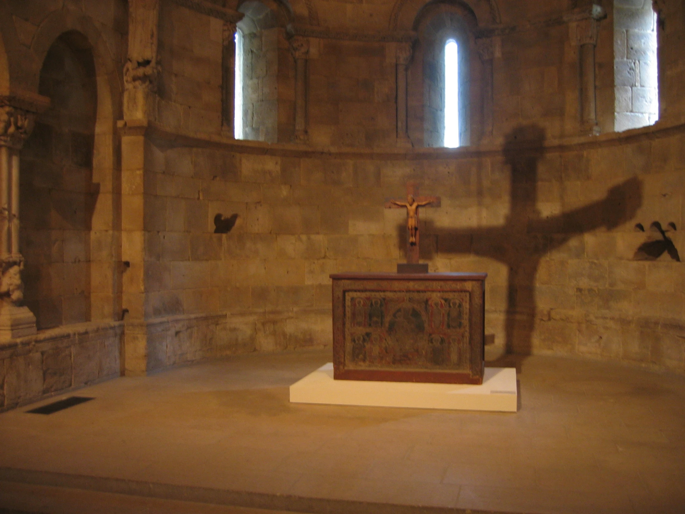 a shadow of someone on the cross in a church