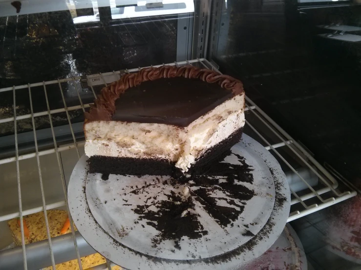 there is a cake sitting on a plate next to the oven