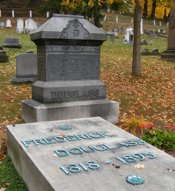 a monument with writing on it in a graveyard