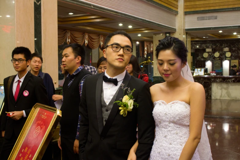 man and woman are standing at the end of the aisle of a wedding