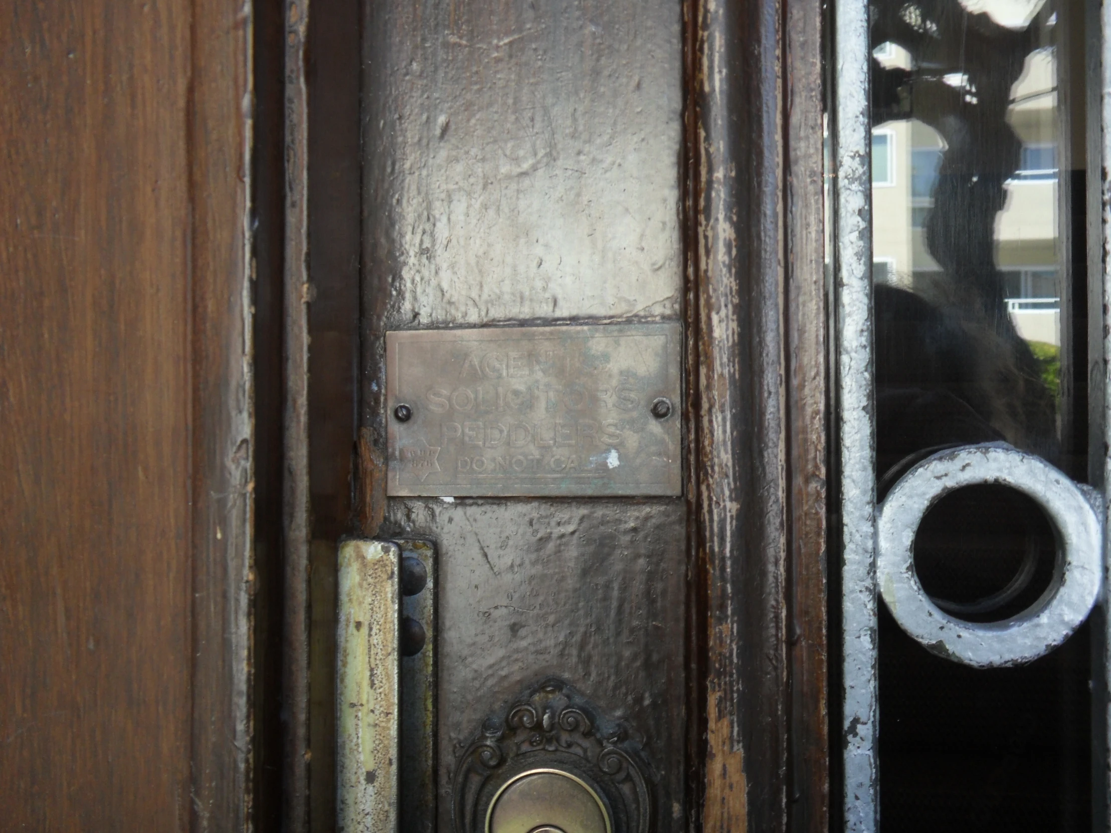 the door to the building is dirty and has a handle