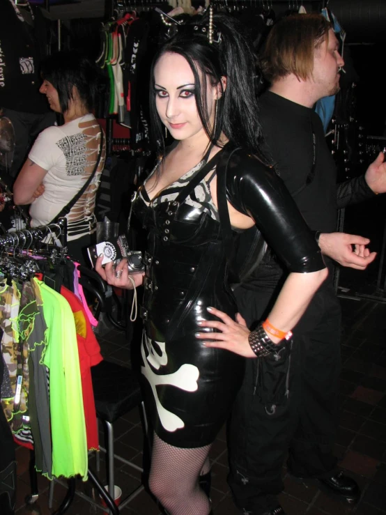 a young woman dressed in black and white posing