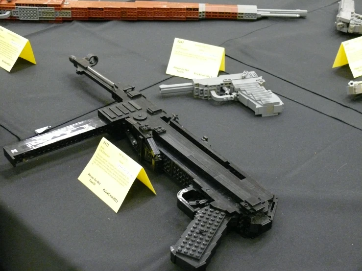 a table with several guns and notes about gun rights