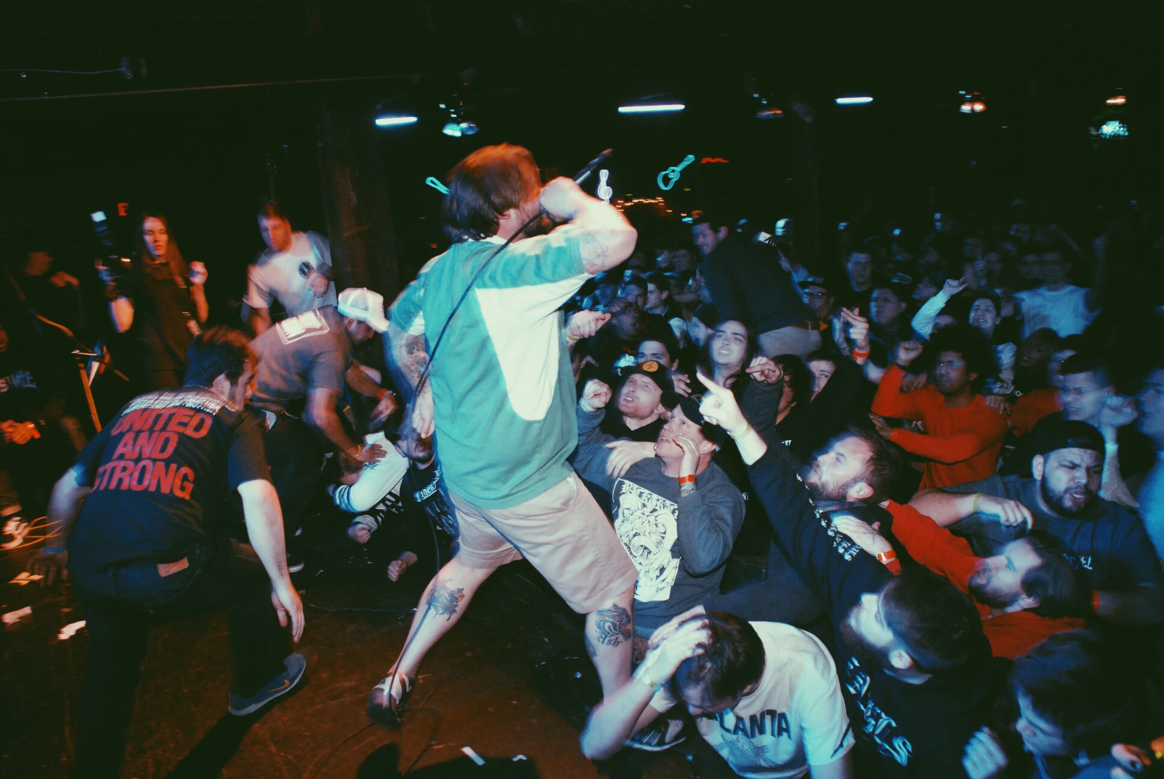 a group of people watching a man on a stage