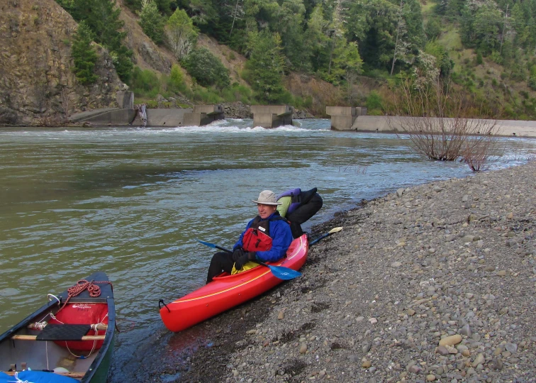 a man and a  paddling a boat in a river