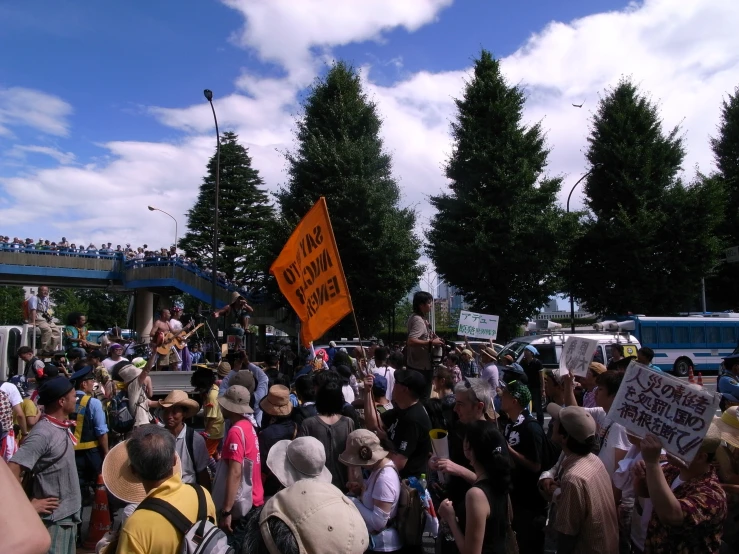 a group of people standing in a park with signs