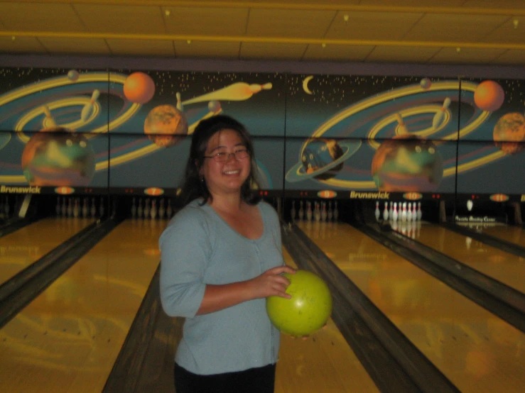 woman holding a bowling ball in her hand
