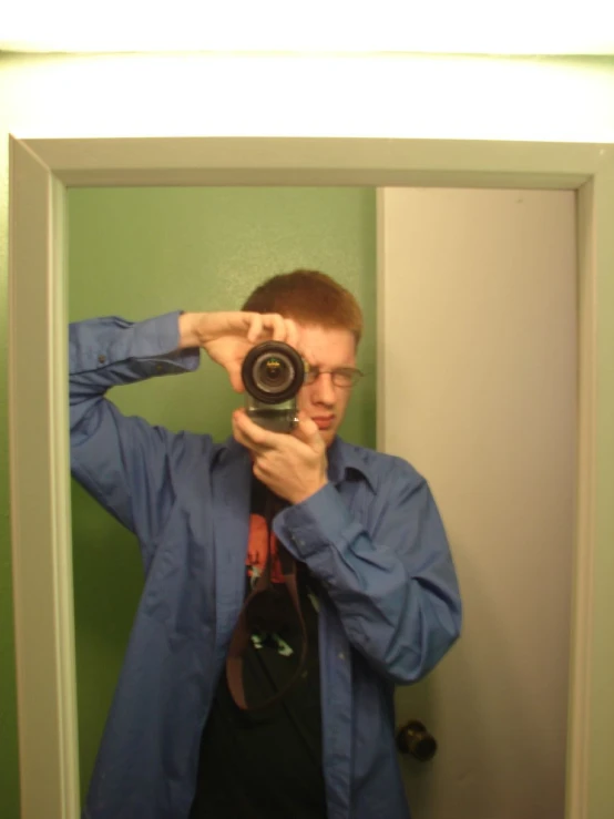 a man taking a selfie in front of a mirror