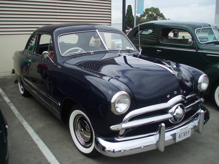 antique black and white sedan parked next to each other