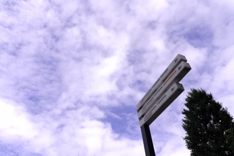 a very tall sign on a very pretty street