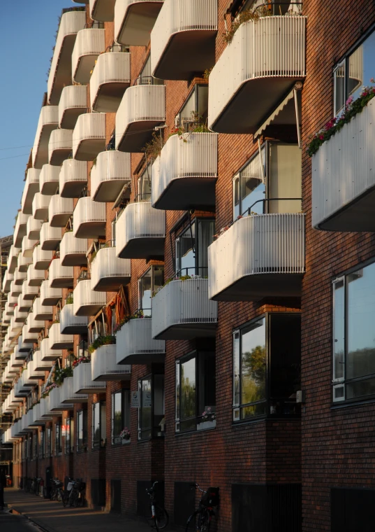 many balconies near each other on a brick building