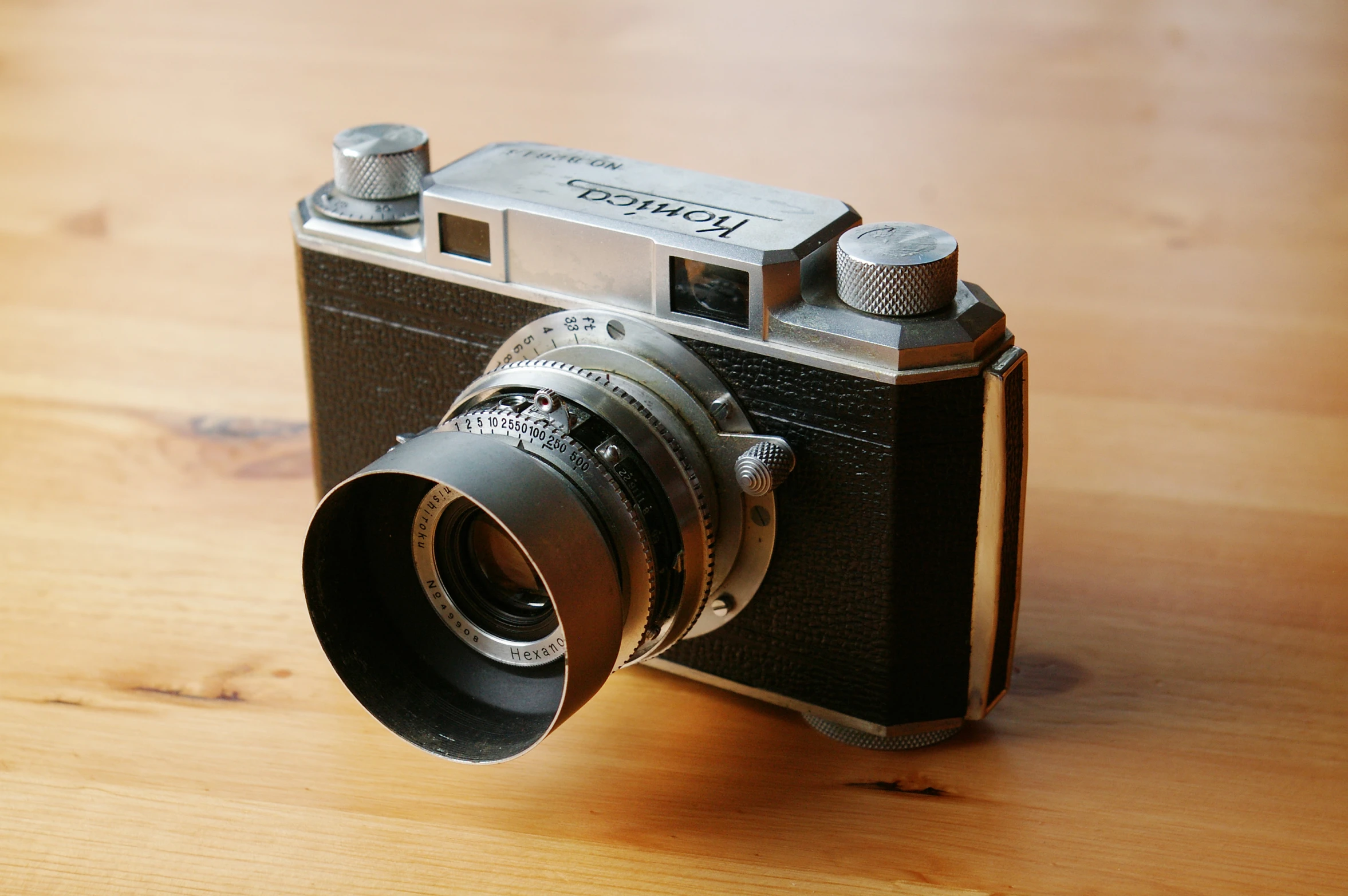 an old - fashioned camera with a lens attached