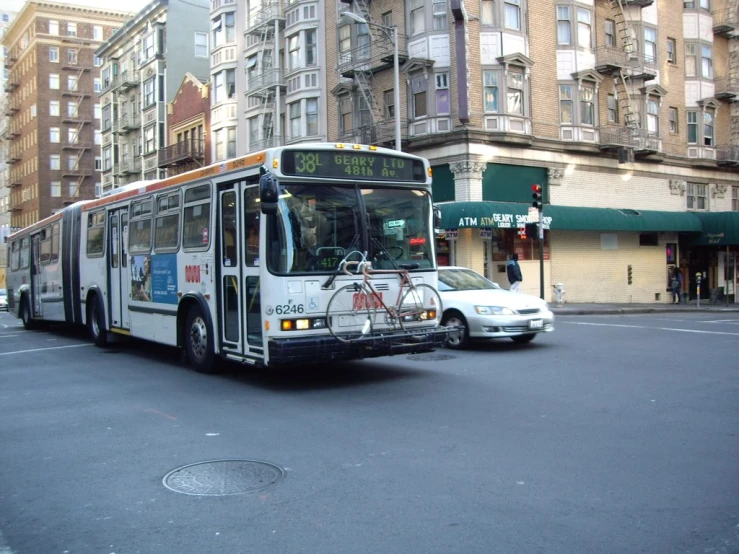 a bus driving down the street next to some buildings