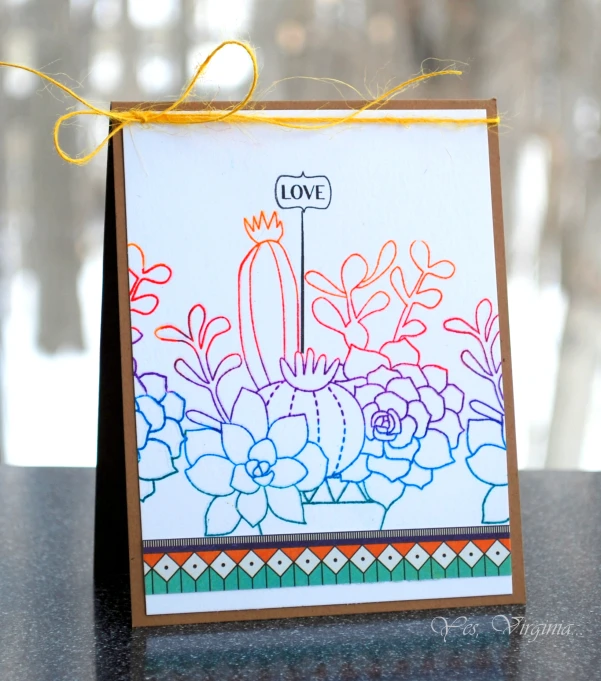 an ornate card with a cactus scene on it