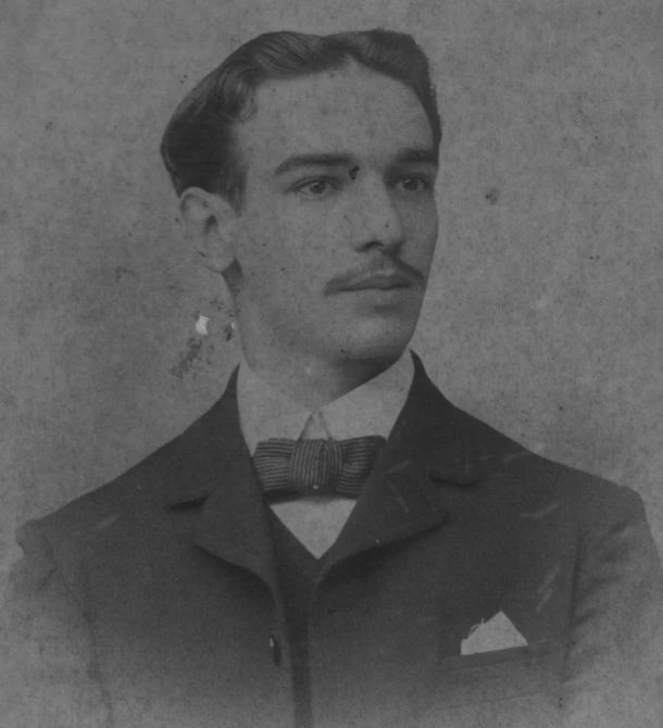 a man wearing a bow tie and suit in black and white