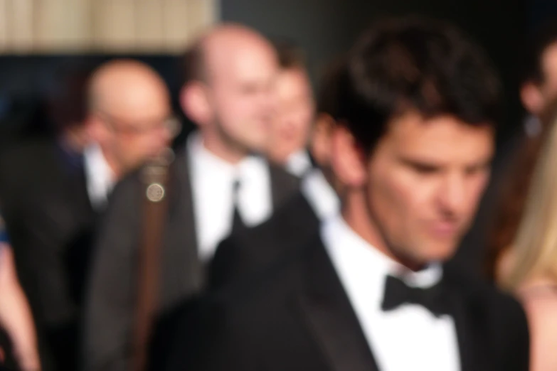 a group of people in suits and ties are outside