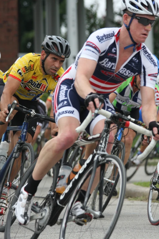 some men on bicycles are going down the road