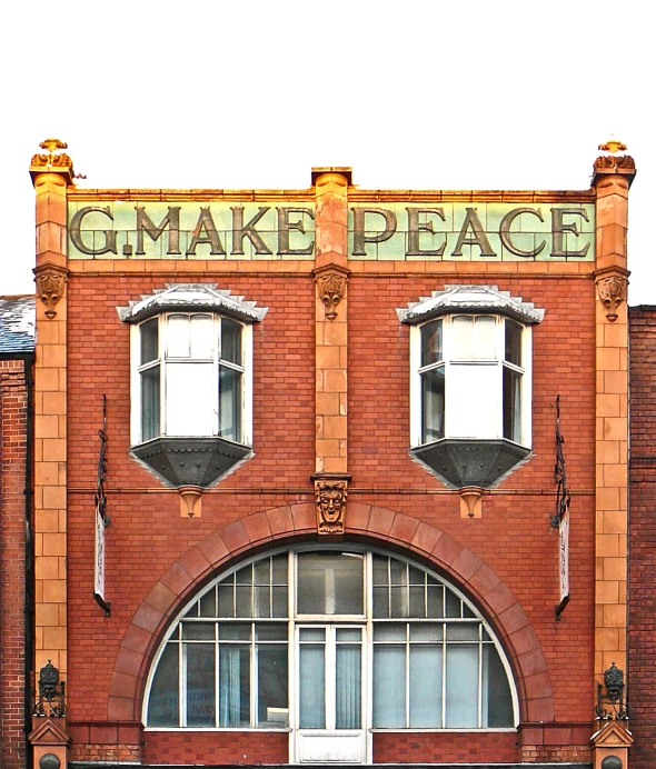 the front of a large brick building with a sign on it