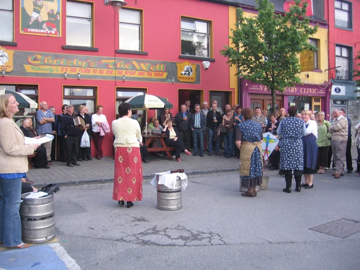 group of people gathered in front of a store to celete