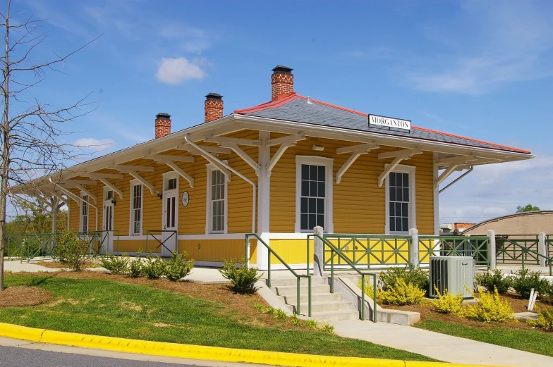 small yellow and red brick building with three chimneys