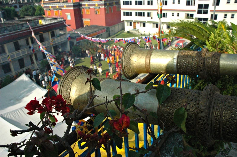 the view from the roof of a building with bells, vines and flowers