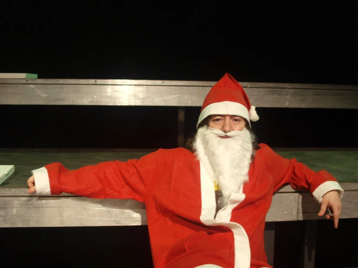 a man dressed up like santa posing for a picture