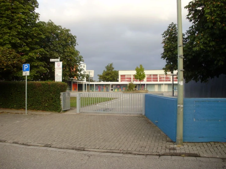 the street has been blocked off by a fenced parking lot