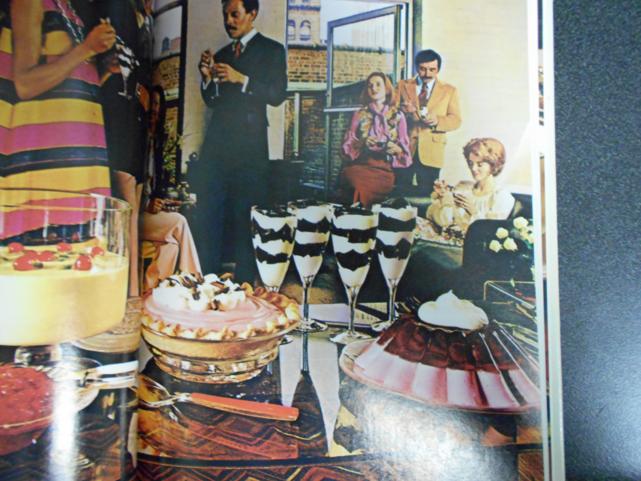 a book of an article showing a couple of people drinking and having cake together