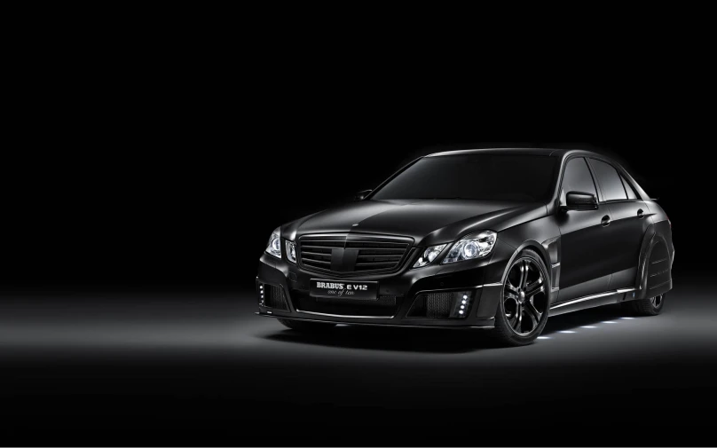 the front view of a black mercedes cla in the dark