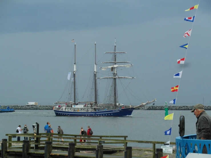 a sailing ship is parked in front of the pier