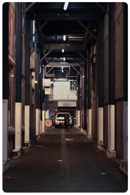 a truck is parked under a roof, on the street