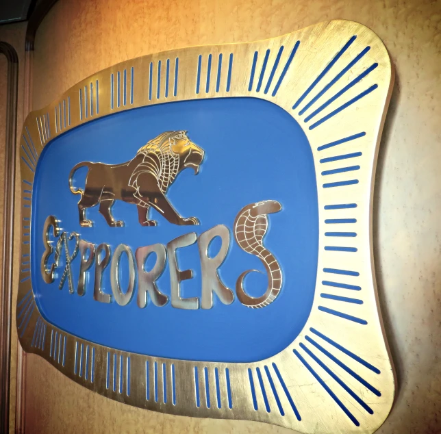 a metal sign of the logo of the dealers of