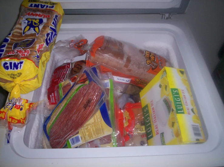 a fridge is filled with many bags and packaged items
