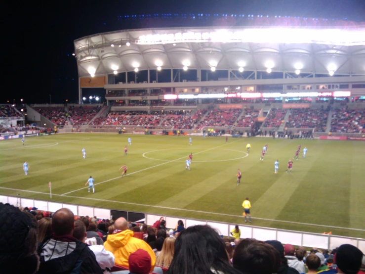 the field of a stadium during a soccer game with a player on the side of the stadium