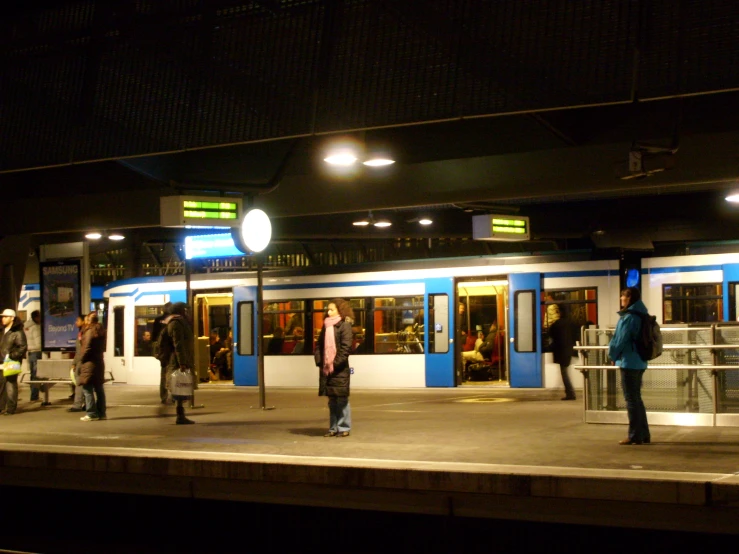 many people standing outside of a train station