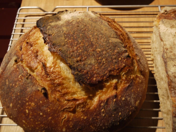 a loaf of bread sits on a cooling rack