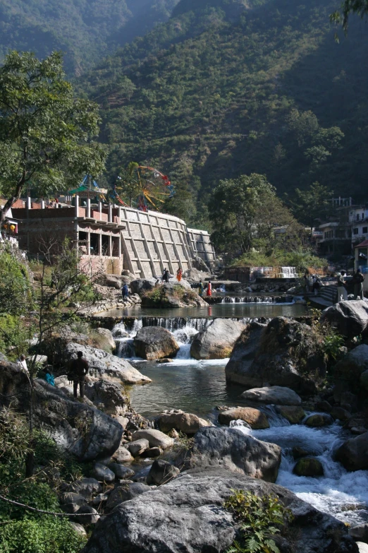 a river running through a city surrounded by mountains