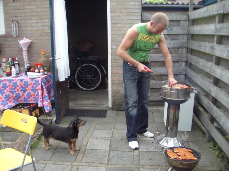 a man grilling chicken on a bbq