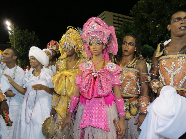 women dressed in bright costumes are gathered together