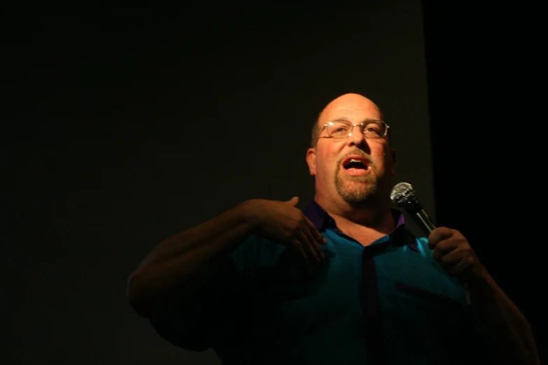 a man is singing with a microphone in his hands