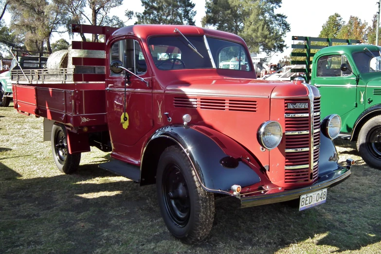 two trucks on display at an antique automobile show