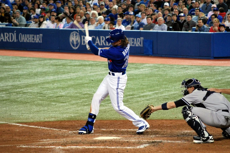 a baseball player hitting a ball on a field