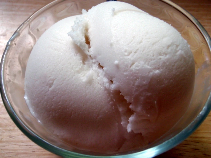 an ice cream scoop in a glass bowl