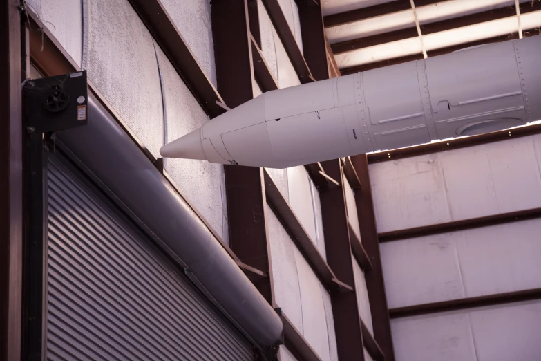 an airplane hangs from the side of the building