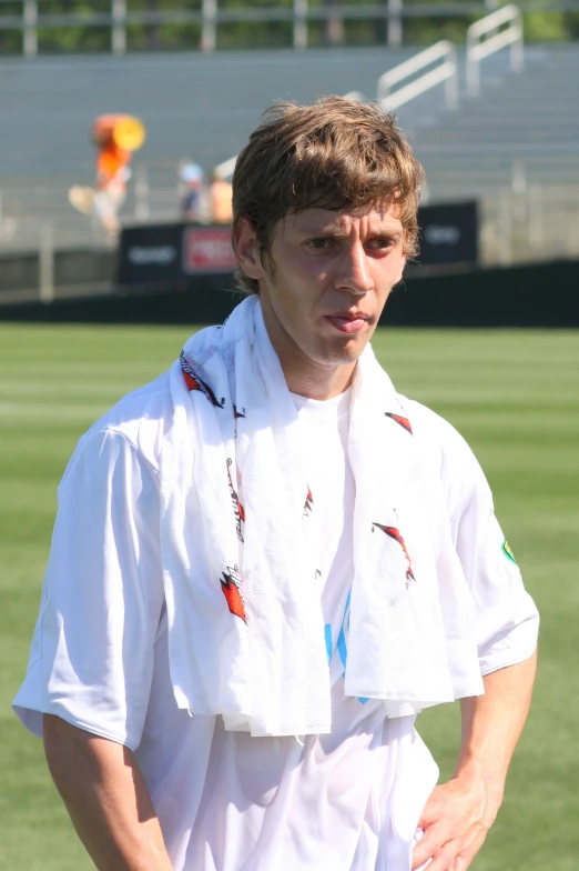 a young man who is wearing a towel and looking concerned