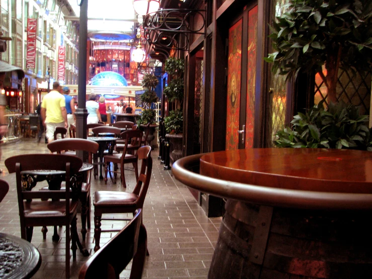 a narrow alley lined with tables and chairs