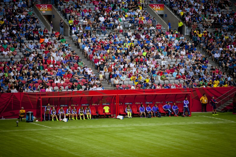 a soccer field with fans and banners at the stands